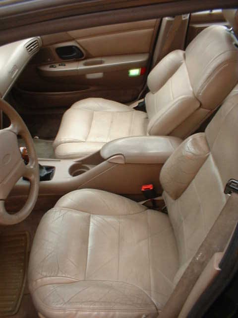 2000 Ford Taurus - Interior view of a car showing tan leather seats and door panel details.