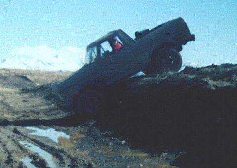 1978 Ford Bronco - This vehicle appears to be stuck in a challenging off-road situation, with its tires deep in mud and the chassis tilted.