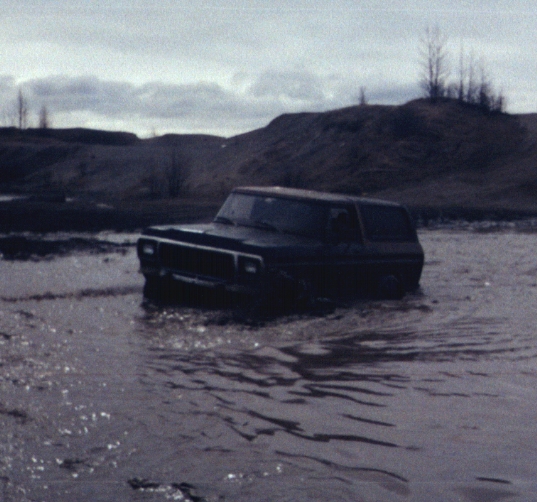 Ford Bronco in muddy water up to its doors during a deep water crossing