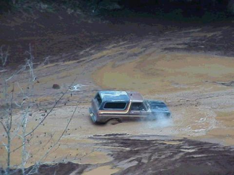 1978 Ford Bronco - This 1978 Ford Bronco navigates a muddy terrain, kicking up dirt as it goes.