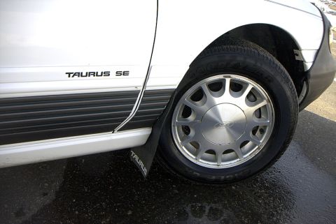 1995 Ford Taurus - Stock Rims, SE badge, and lower accent color. Havent seen any other tauruses w/ it! It is not paint but a trim piece.