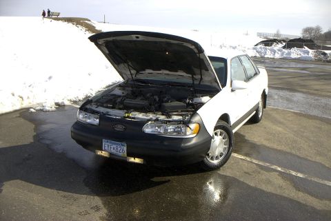 1995 Ford Taurus - Front driver shot with the hood up.