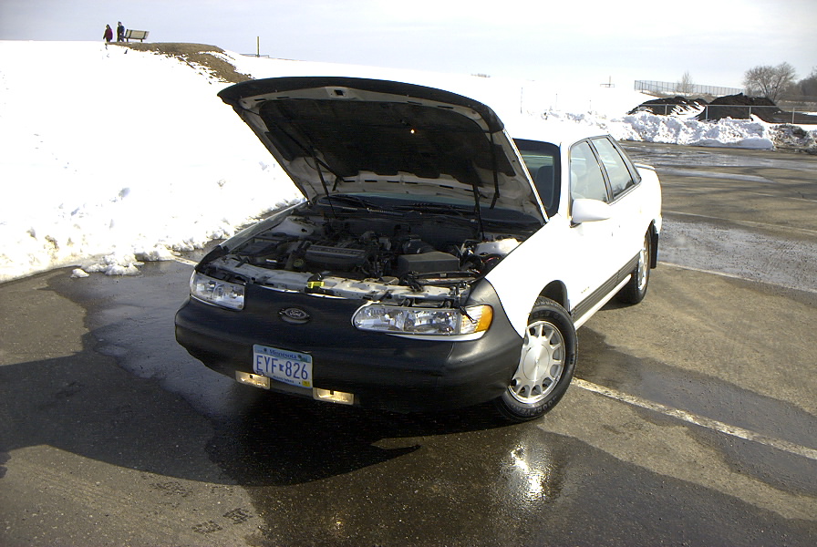 Front driver shot with the hood up.