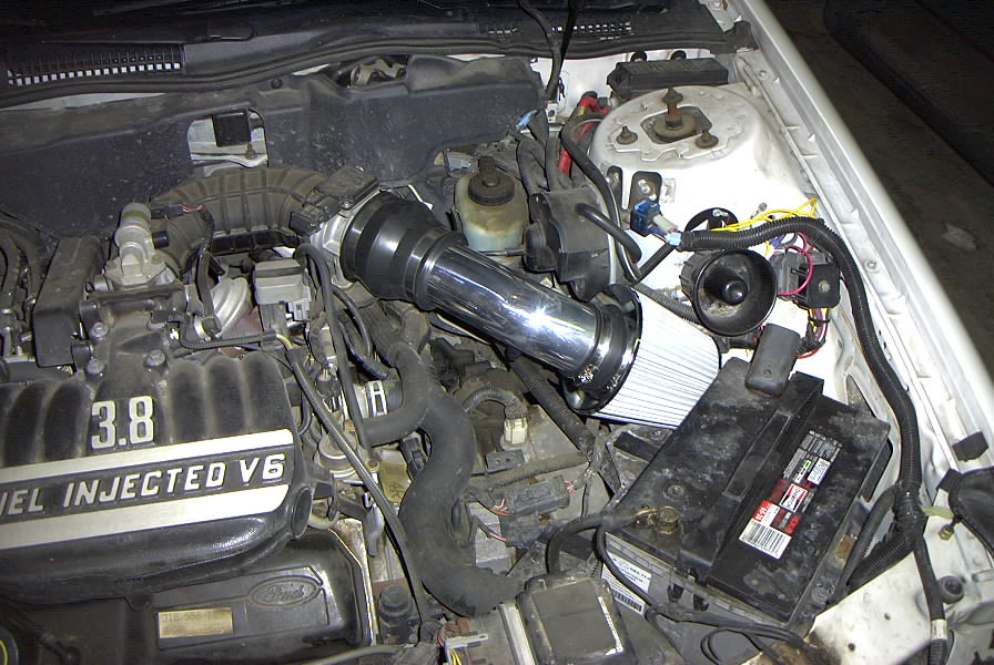 Engine bay of Ford 3.8L V6 with chrome cone air intake and FUEL INJECTED V6 valve cover