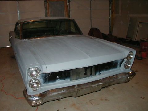 1965 Mercury Comet - The front grille and bumper of a 1966 Ford Fairlane 500 are visible, with the car in primer.