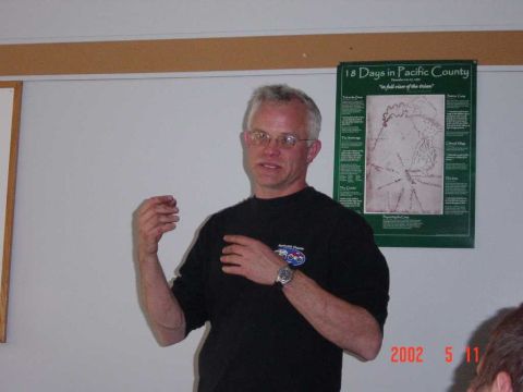 1996 Ford Bronco - A man gestures while speaking, with a poster titled '18 Days in Pacific County' visible on the wall.