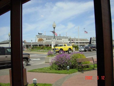 1996 Ford Bronco - Yellow Ford Bronco parked on street in front of Marsh's Free Museum.