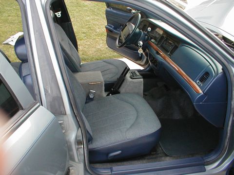 1995 Ford Crown Victoria - Interior view of a 1995 Ford Crown Victoria, its cloth seats and wood-accented dashboard.