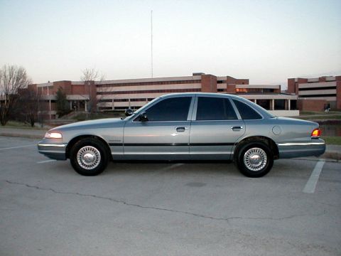 1995 Ford Crown Victoria - Side profile of a 1995 Ford Crown Victoria sedan parked outdoors.