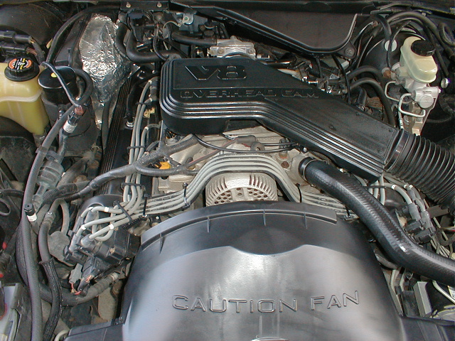 Engine bay showing V8 Overhead Cam intake and Caution Fan shroud in a Ford Crown Victoria