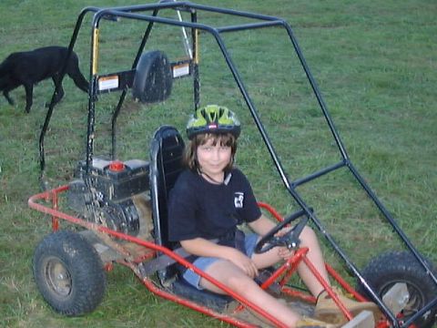 1987 Ford Bronco - Back at camp, one of Morris' daughters test drives his go-cart. Several people rode it Friday night.