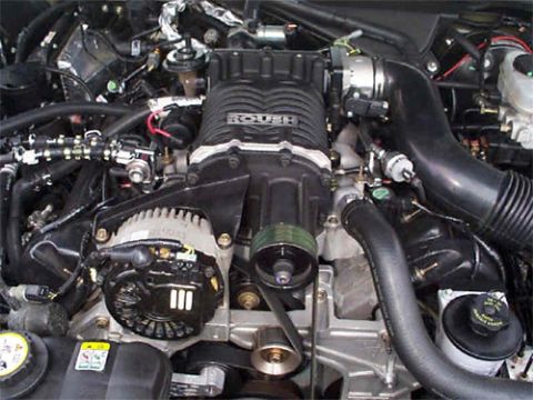 2001 Ford Crown Victoria - Close-up view of a vehicle's engine bay, highlighting a prominent Roush supercharger and alternator.