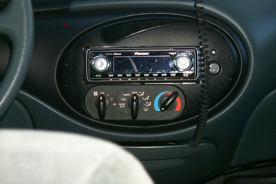 Aftermarket Pioneer head unit and climate controls in oval dash panel of a Ford Taurus interior