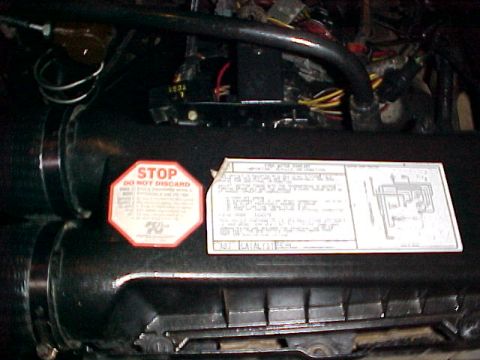 1988 Ford Bronco - Engine compartment view a STOP DO NOT DISCARD label and a technical diagram.