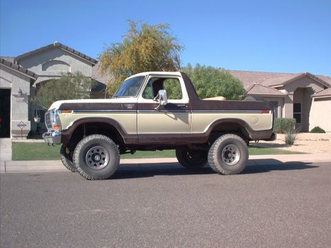 1979 Ford Bronco - Side view of a two-tone Ford Bronco parked on a street.
