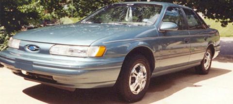 1993 Ford Taurus - A 1993 Ford Taurus sedan is shown from the front three-quarter angle.