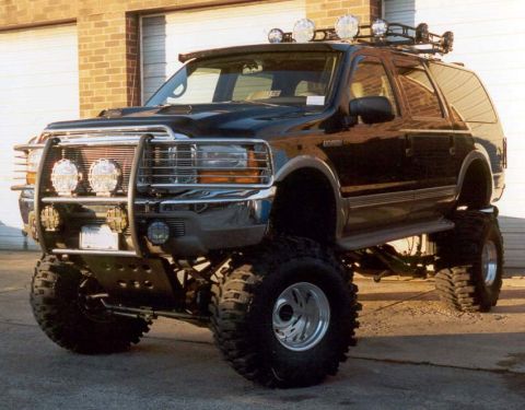 2001 Ford Excursion - This modified 2001 Ford Excursion features a lifted suspension, large off-road tires, and a custom brush guard.