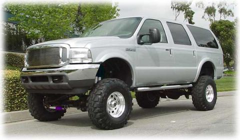 2001 Ford Excursion - This lifted 2001 Ford Excursion features prominent off-road tires and a silver exterior.