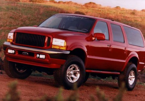 2001 Ford Excursion - Red 2001 Ford Excursion SUV on a dirt road.
