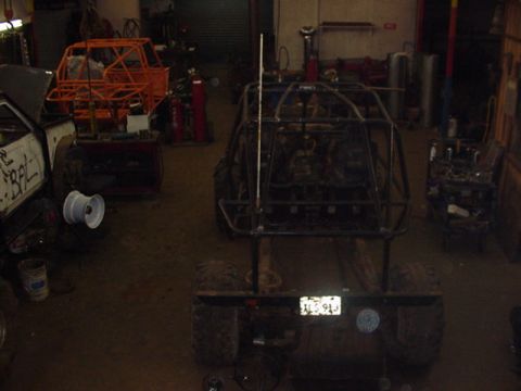 1979 Ford Bronco - Custom buggy frame in a workshop setting, with another vehicle frame in the background.