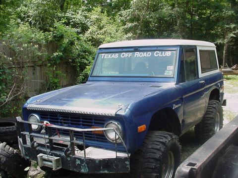 1979 Ford Bronco - This blue Ford Bronco has been modified for off-road use and displays a club sticker on its windshield.