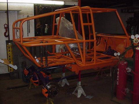 1979 Ford Bronco - This custom off-road buggy chassis is undergoing work in a garage setting.
