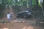 1979 Ford Bronco - Off-road vehicle stuck in mud, with two people observing the situation.