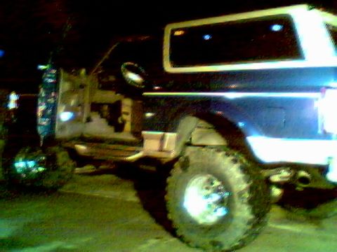 1996 Ford Bronco - Side profile of a 1996 Ford Bronco, showing its distinctive body style and window trim.