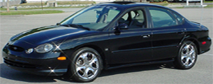 1998 Ford Taurus - A black sedan is parked on asphalt, with a watermark at the bottom right.