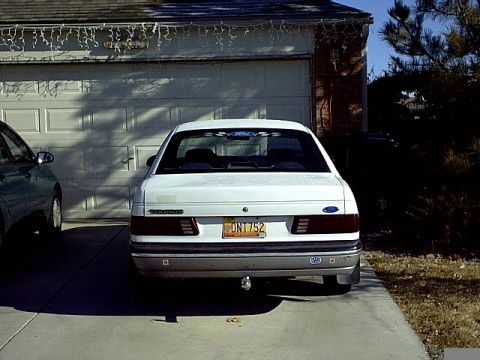 1991 Ford Taurus - This 1991 Ford Taurus is seen from the rear, parked in a driveway in front of a garage.