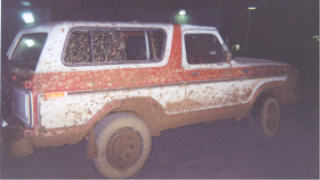 1978 Ford Bronco - A muddy 1978 Ford Bronco is seen from the side, appearing to be at a car wash.