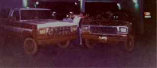 1978 Ford Bronco - Two trucks are parked together, possibly at a garage or car wash.