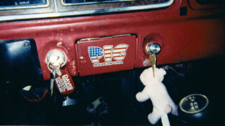 1978 Ford Bronco - Close-up of a vehicle's dashboard a "PIG" emblem and keys in the ignition.