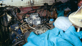 1978 Ford Bronco - Close-up view of an engine bay, a carburetor and covered in blue tarps.