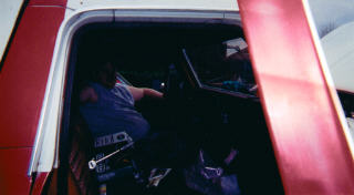 1978 Ford Bronco - Interior view of a person sitting in the driver's seat of a vehicle, holding a wrench.