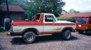 1978 Ford Bronco - Two-tone 1978 Ford Bronco parked outdoors with a red SUV nearby.