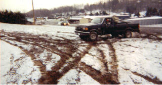 1990 Ford F-150 - Slinging mud and snow in my grannys field on christmas day, I made it up this small hill while still in 2wd, lmao the car in the background…