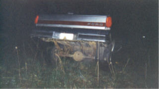 1990 Ford F-150 - Rear view of a 1990 Ford F-150 pickup truck at night, partially obscured by grass.