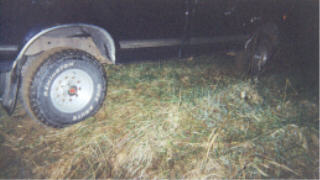 1990 Ford F-150 - A close-up view of a truck's tire, showing the BFGoodrich brand. The rest of the vehicle is obscured by darkness.