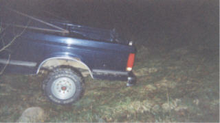 1990 Ford F-150 - Rear view of a 1990 Ford F-150 pickup truck parked in a field at night.