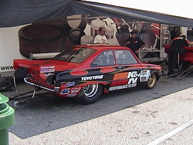 Red and black drag car with K&N Performance Filters and Toyo Tires decals, side view