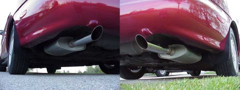 1998 Ford Taurus - Close-up view of the dual exhaust system on a red vehicle, with a watermark from SuperMotors.net visible.