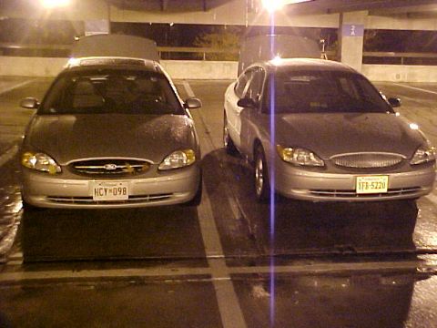 2001 Ford Taurus - Two Ford Taurus sedans from around 2001 are shown from the front in a parking area.