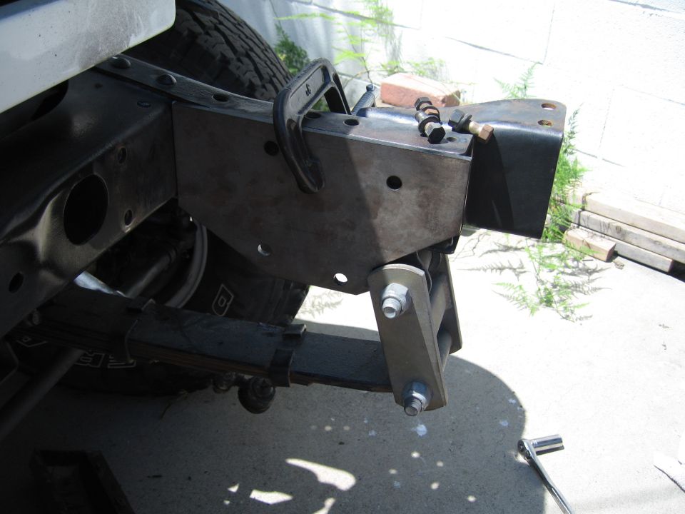 Bare steel fabricated rear bumper bracket welded to 4x4 frame with tow loop