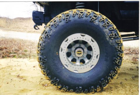1988 Ford Bronco - Off-road tire and wheel detail, showing aggressive tread pattern and custom rim.