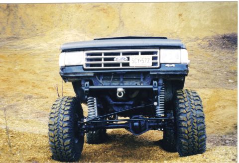 1988 Ford Bronco - This heavily modified Ford truck features an aggressive stance with oversized tires and a lifted suspension, ready for off-road adventures.