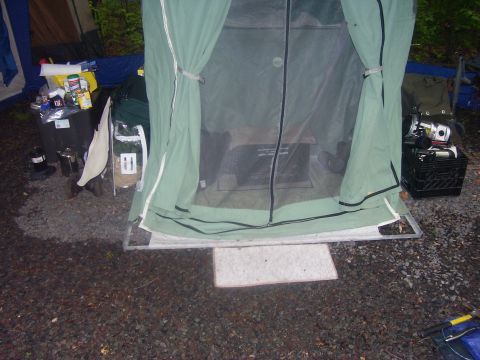 1991 Ford Bronco - A campsite scene shows a tent with a screened door, surrounded by camping equipment and supplies.
