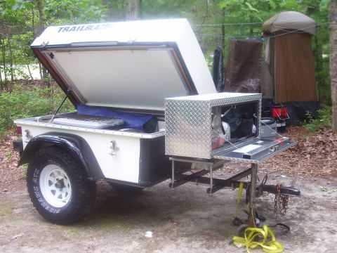 1991 Ford Bronco - A small white off-road utility trailer labeled "TRAILBLAZER" with its top clamshell lid open, fitted with off-road tires (Firehawk ATX) on…