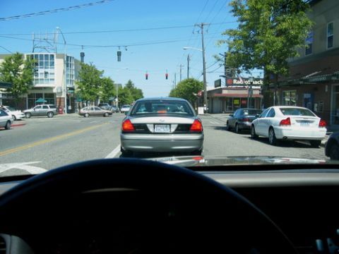 1999 Ford Crown Victoria - Driving behind a Ford Crown Victoria in traffic, with a white Volvo S60 in the next lane.