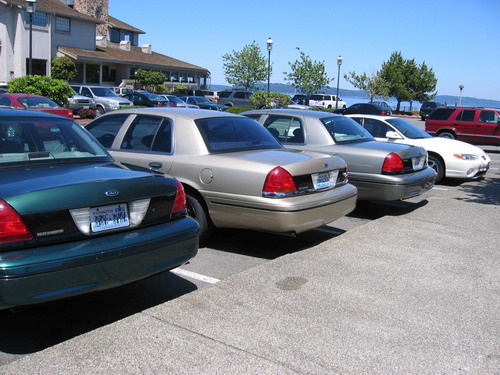 Rear view of a gold 1998 Ford Crown Victoria parked in a lot